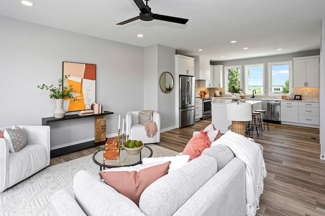 2712 Fleur Dr, Des Moines, IA 50321 - living area featuring ceiling fan, recessed lighting, wood finished floors, and baseboards