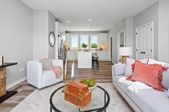 2738 Fleur Dr Unit 23, Des Moines, IA 50321 - living room featuring light wood finished floors, recessed lighting, and baseboards