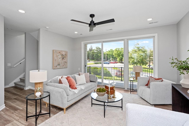 2738 Fleur Dr Unit 23, Des Moines, IA 50321 - living room featuring ceiling fan, wood finished floors, stairway, recessed lighting, and baseboards