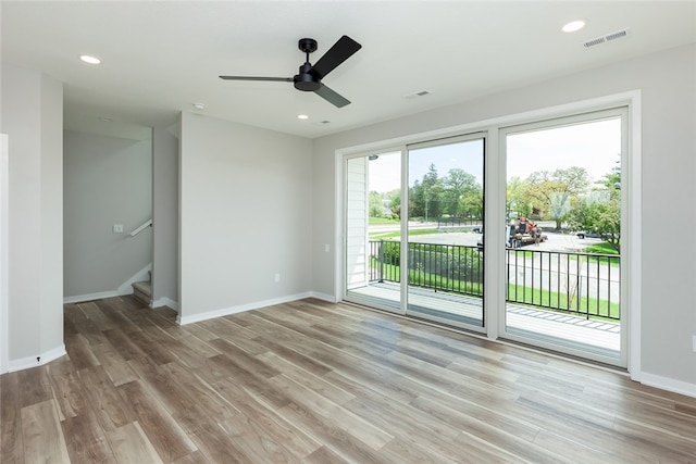 empty room with light hardwood / wood-style floors and ceiling fan