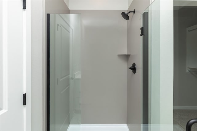 bathroom featuring a shower with door