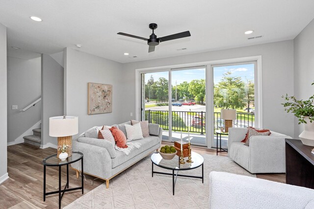 2714 Fleur Dr Unit 11, Des Moines, IA 50321 - living room featuring ceiling fan, wood finished floors, stairway, recessed lighting, and baseboards
