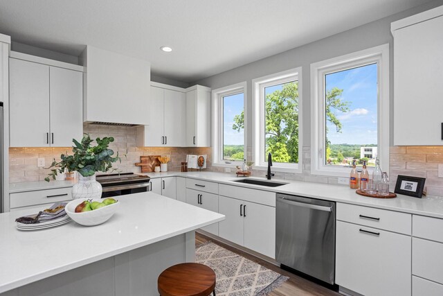 2714 Fleur Dr Unit 11, Des Moines, IA 50321 - kitchen with stainless steel appliances, a sink, light countertops, recessed lighting, and backsplash