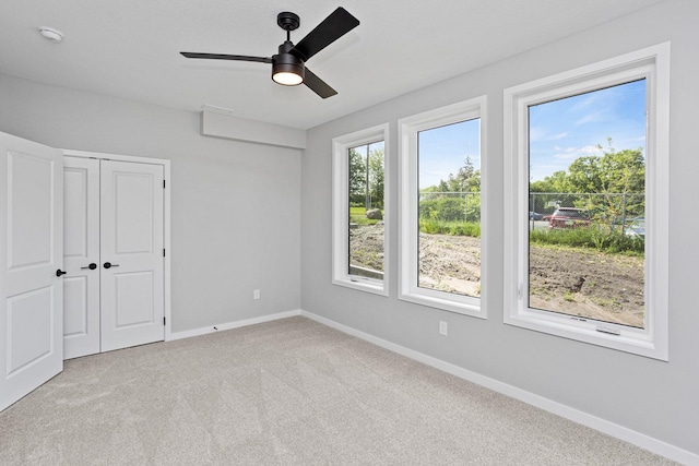 2714 Fleur Dr Unit 11, Des Moines, IA 50321 - unfurnished bedroom featuring baseboards, carpet floors, a closet, and a ceiling fan