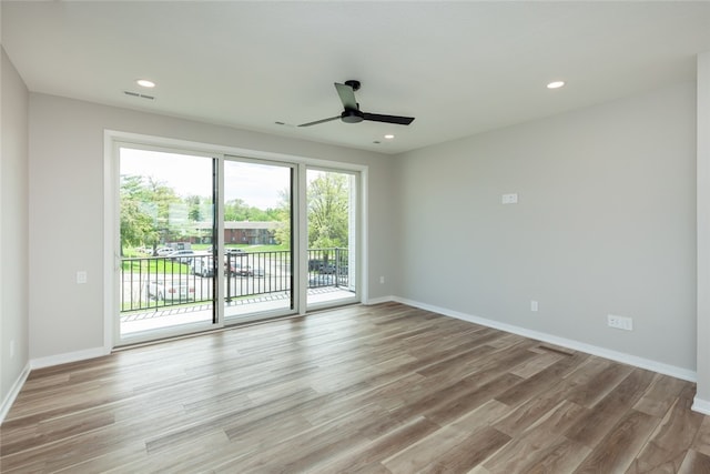 empty room with ceiling fan and light wood-type flooring