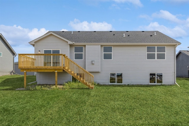 rear view of property featuring a lawn and a wooden deck