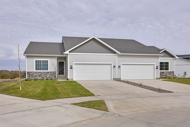 view of front facade featuring a garage and a front lawn