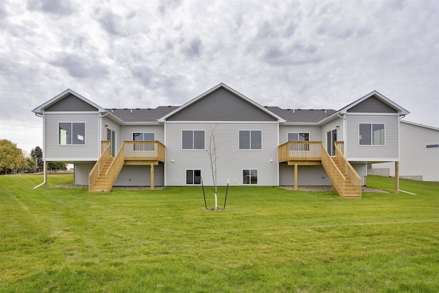 rear view of house with a yard and a deck