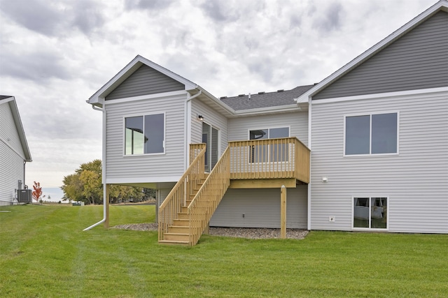 rear view of property featuring a yard and a deck