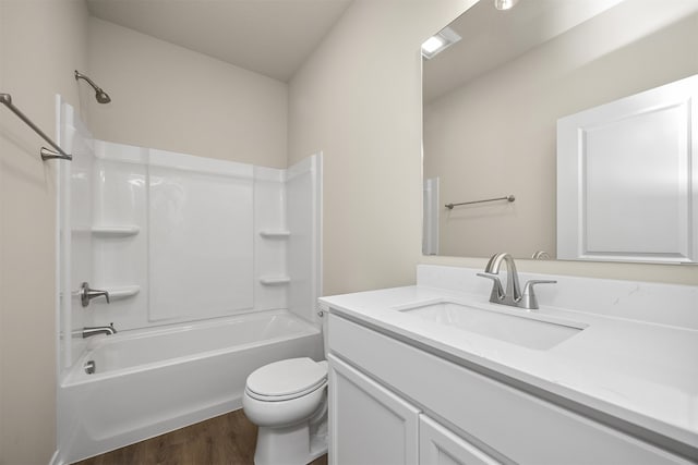 full bathroom featuring vanity, toilet, bathtub / shower combination, and hardwood / wood-style floors