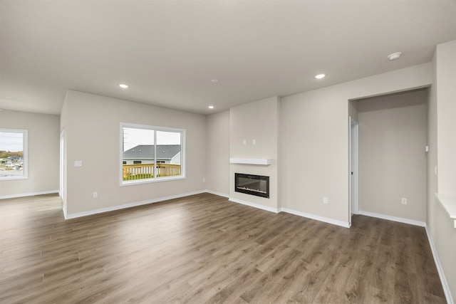 unfurnished living room with wood-type flooring