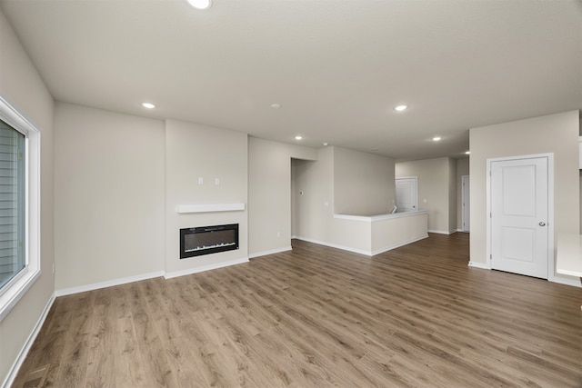 unfurnished living room with light hardwood / wood-style floors