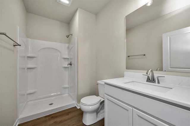 bathroom with vanity, hardwood / wood-style flooring, toilet, and walk in shower