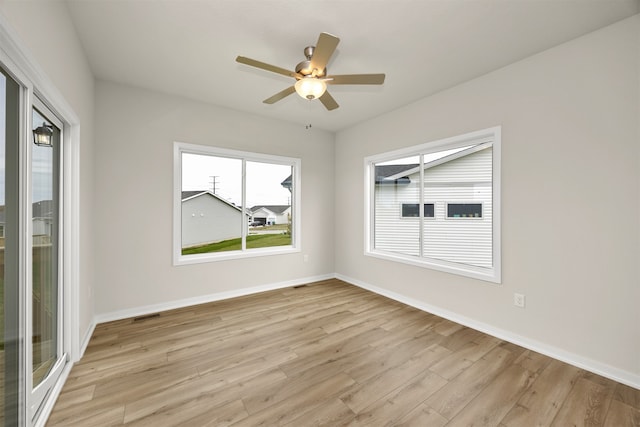 empty room with light hardwood / wood-style floors and ceiling fan