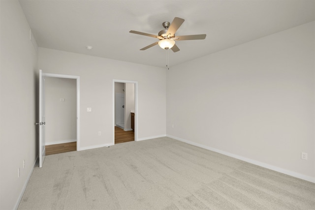 unfurnished bedroom with light carpet and ceiling fan