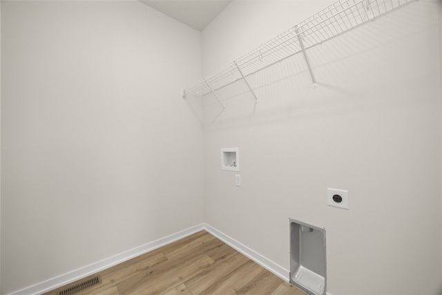 washroom featuring hookup for an electric dryer, hardwood / wood-style flooring, and washer hookup