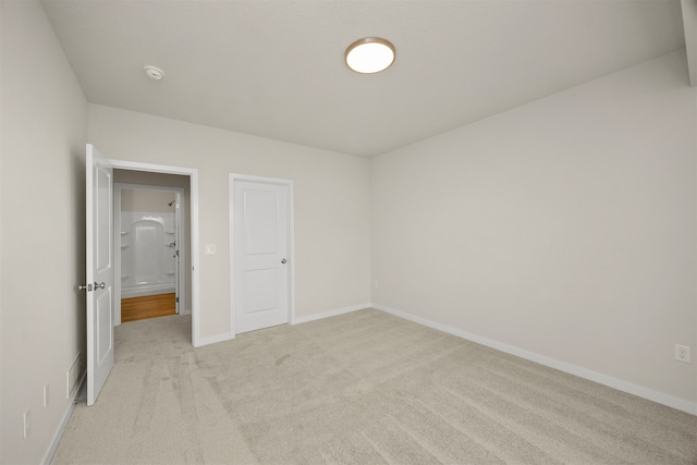 unfurnished bedroom featuring light colored carpet