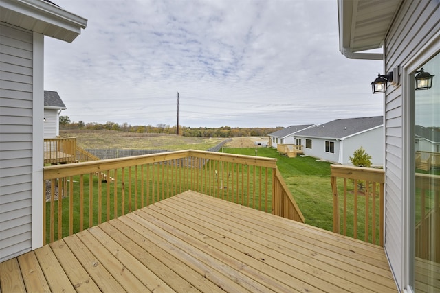 wooden deck featuring a lawn