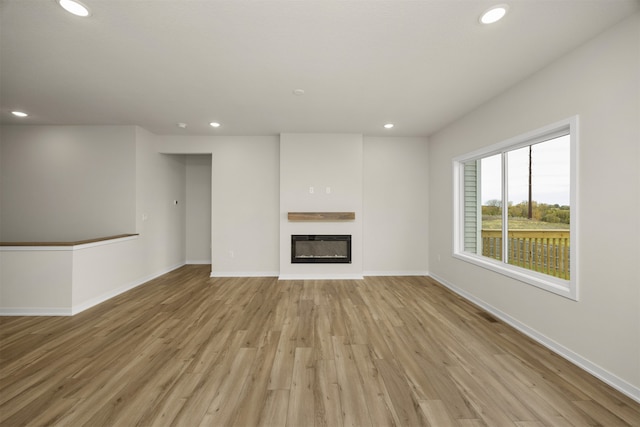 unfurnished living room with light hardwood / wood-style flooring