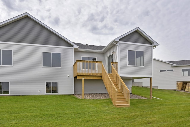 back of house with a deck and a lawn