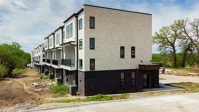 view of building exterior with central air condition unit