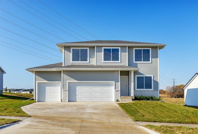 view of front of home featuring a front lawn and a garage