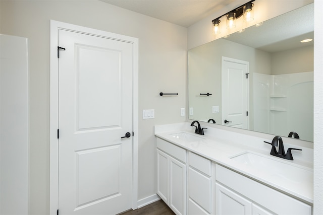 bathroom with vanity, a textured ceiling, and hardwood / wood-style flooring