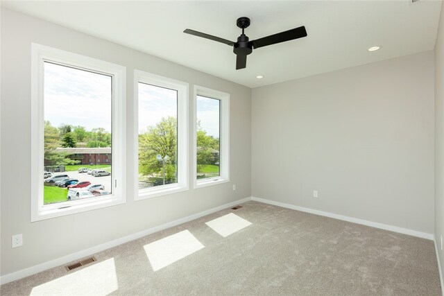 empty room with ceiling fan and carpet floors