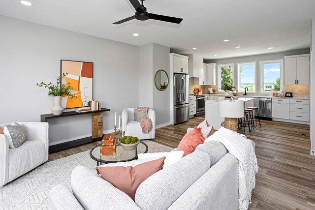 2728 Fleur Dr Unit 18, Des Moines, IA 50321 - living area featuring ceiling fan, recessed lighting, wood finished floors, and baseboards
