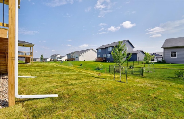 view of yard featuring a residential view and fence