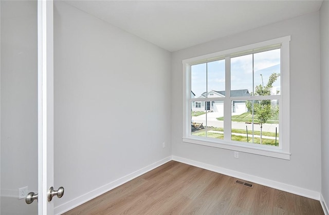 spare room with visible vents, plenty of natural light, and baseboards