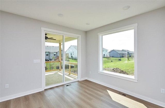 entryway featuring wood finished floors, visible vents, and baseboards