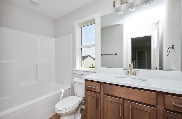 bathroom featuring bathing tub / shower combination, vanity, and toilet