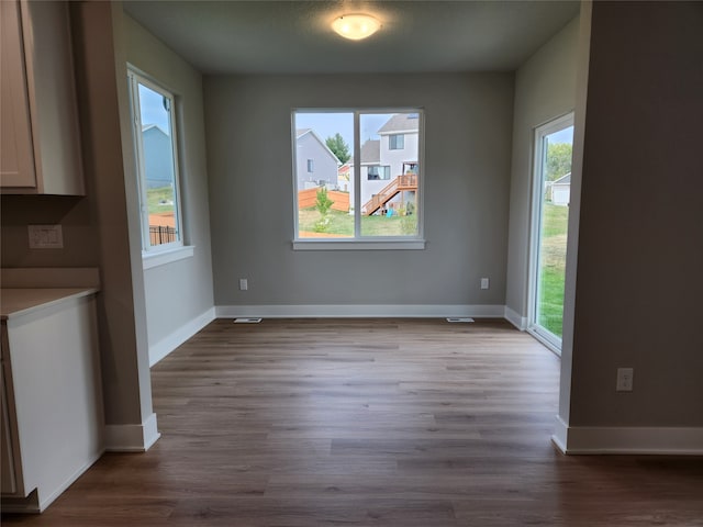 unfurnished dining area featuring hardwood / wood-style flooring