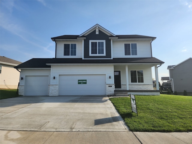 view of front of home featuring a garage and a front lawn