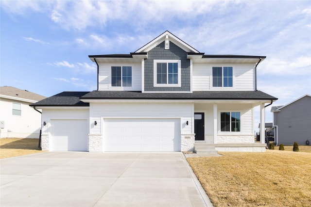 view of front of home featuring a garage, a porch, and a front lawn