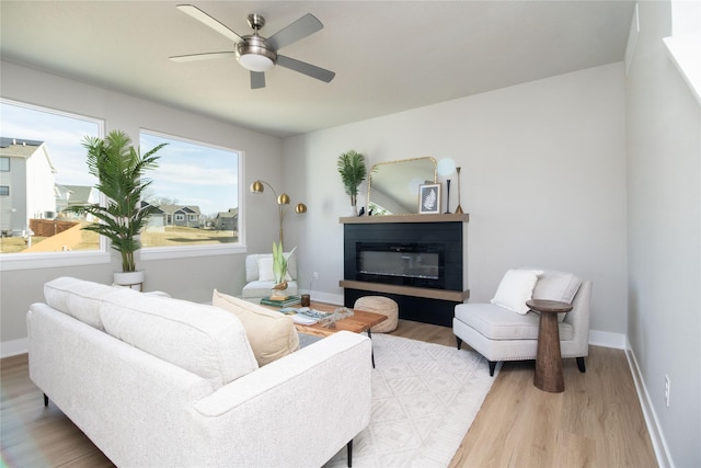 living room with ceiling fan and light hardwood / wood-style floors