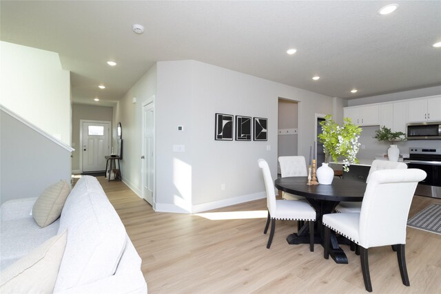 dining space with light hardwood / wood-style flooring