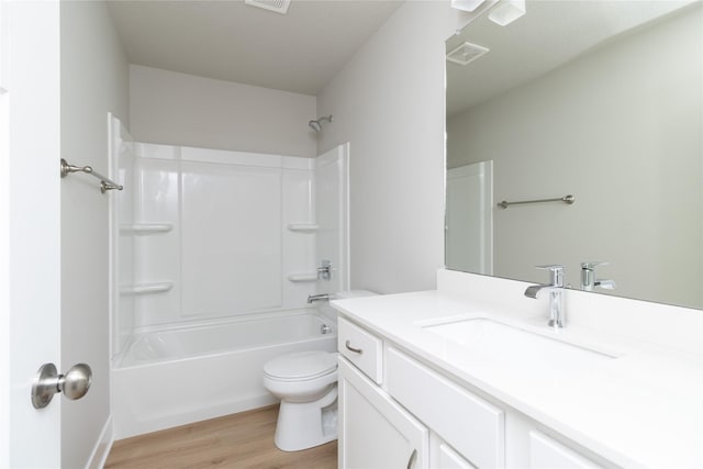 full bathroom with vanity, hardwood / wood-style flooring, bathing tub / shower combination, and toilet