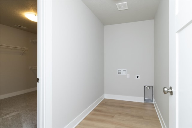 laundry area with washer hookup, hookup for an electric dryer, and light hardwood / wood-style flooring