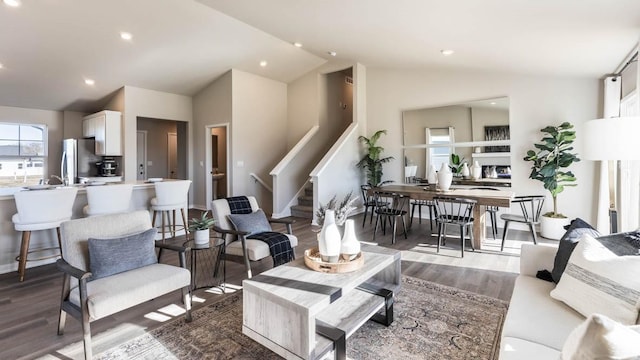 living area with stairs, recessed lighting, lofted ceiling, and dark wood-style floors