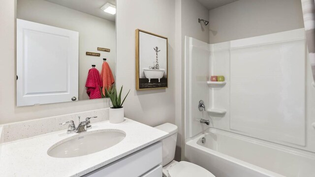 full bathroom featuring tub / shower combination, vanity, and toilet