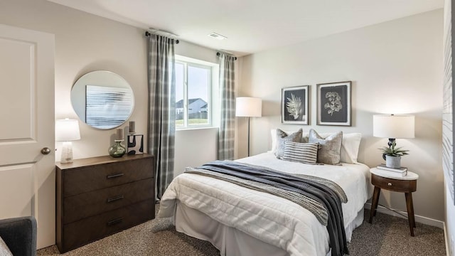 bedroom with baseboards, visible vents, and carpet flooring