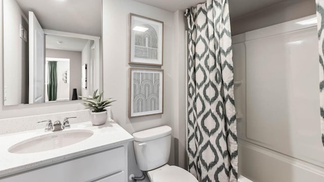 bathroom with toilet, shower / tub combo with curtain, and vanity