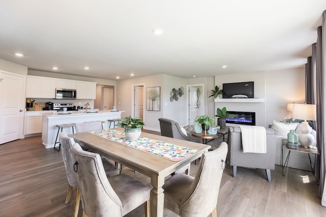 dining space with light hardwood / wood-style floors