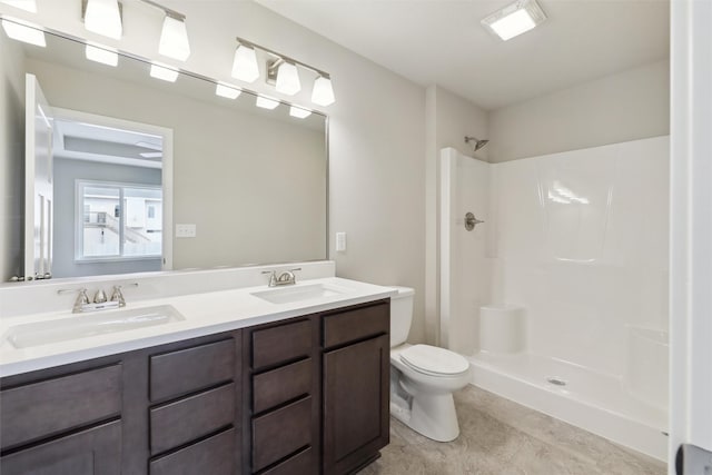 bathroom with toilet, vanity, and walk in shower