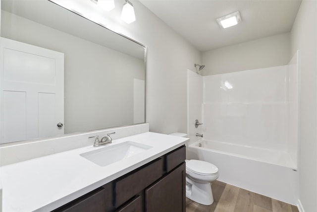 full bathroom with bathing tub / shower combination, toilet, vanity, and hardwood / wood-style flooring