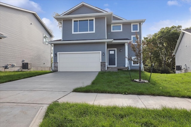 view of front of home with a garage, central AC, and a front yard