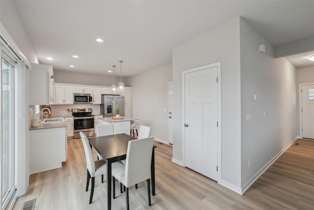 dining room featuring recessed lighting, visible vents, light wood-style flooring, and baseboards