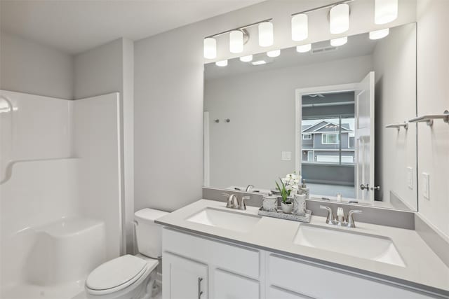 bathroom with vanity, toilet, and walk in shower